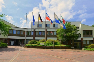 Gemeindeverwaltung Trittau am Europaplatz Außenansicht der Gemeindeverwaltung Trittau am Europaplatz mit Fahnen vor dem Eingang. © Verena Künstner